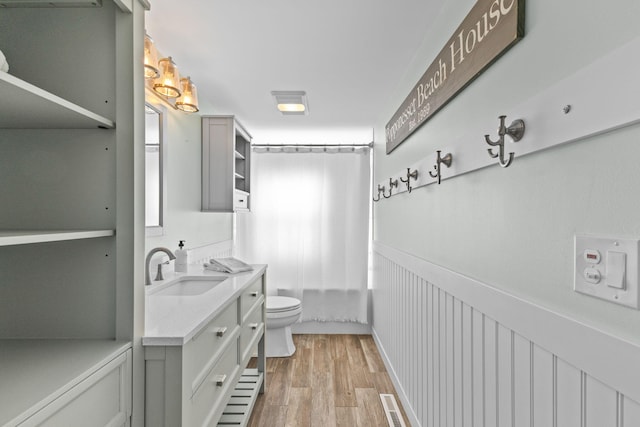 full bathroom featuring shower / bath combination with curtain, vanity, toilet, and hardwood / wood-style floors