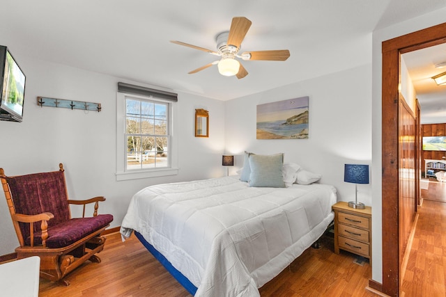 bedroom featuring wood-type flooring and ceiling fan