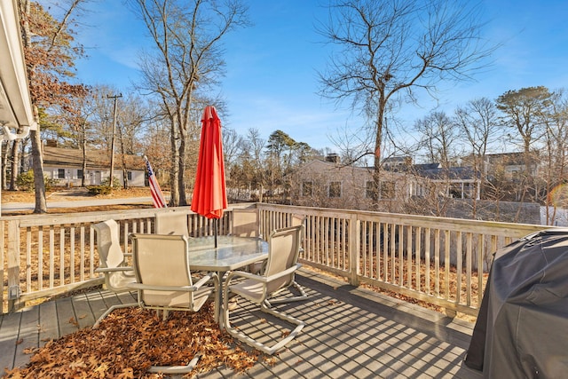 wooden terrace with a grill
