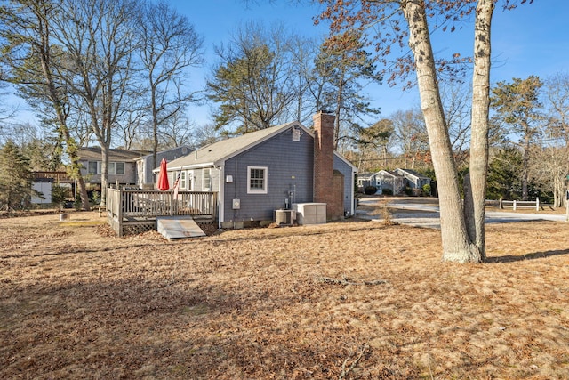 view of side of property featuring cooling unit and a deck