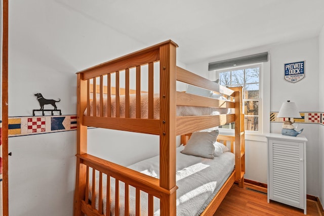 bedroom with hardwood / wood-style floors