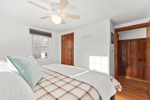 bedroom with hardwood / wood-style flooring and ceiling fan