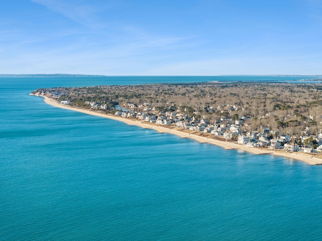 birds eye view of property with a water view and a view of the beach