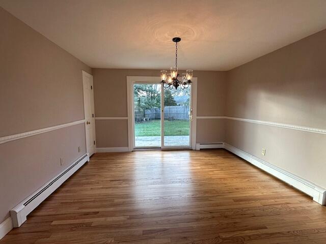 2 Stiles Rd, South Yarmouth, MA 02664 - unfurnished dining area with a baseboard radiator, a chandelier, wood finished floors, and baseboards