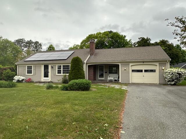 2 Stiles Rd, South Yarmouth, MA 02664 - single story home featuring an attached garage, a chimney, a front lawn, asphalt driveway, and solar panels