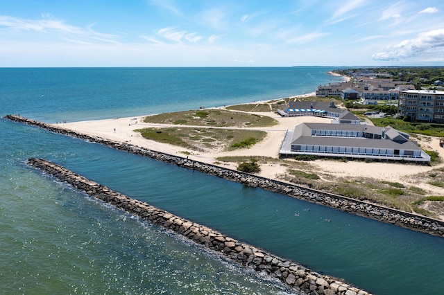 birds eye view of property featuring a water view and a beach view