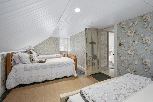 73 Division St, West Harwich, MA 02671 - carpeted bedroom with wallpapered walls, vaulted ceiling, and recessed lighting