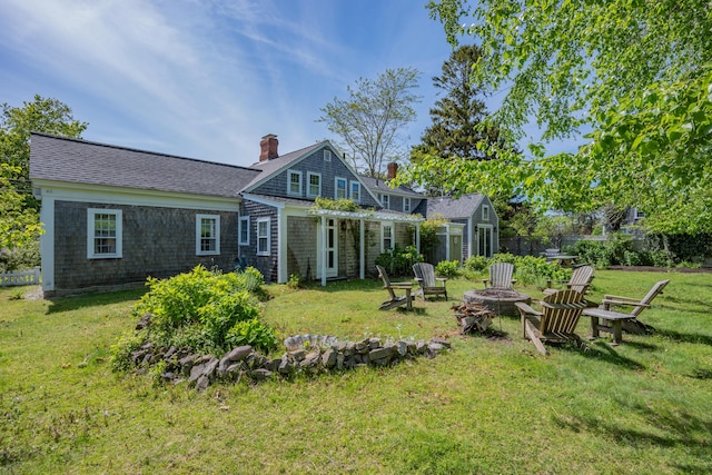 73 Division St, West Harwich, MA 02671 - back of property featuring a fire pit and a chimney