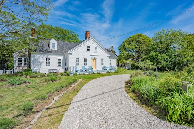 73 Division St, West Harwich, MA 02671 - view of front of house with a chimney and a front yard