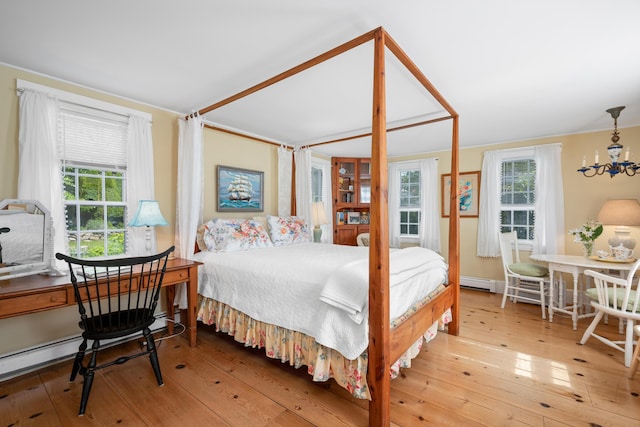 73 Division St, West Harwich, MA 02671 - bedroom featuring a chandelier, a baseboard heating unit, hardwood / wood-style flooring, and a baseboard radiator