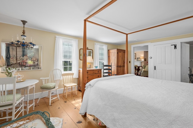 73 Division St, West Harwich, MA 02671 - bedroom featuring light wood finished floors and a chandelier