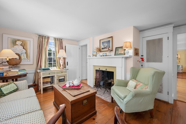 73 Division St, West Harwich, MA 02671 - living room featuring hardwood / wood-style floors and a fireplace with flush hearth