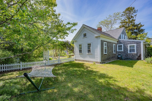 73 Division St, West Harwich, MA 02671 - view of side of property with a chimney and a shingled roof