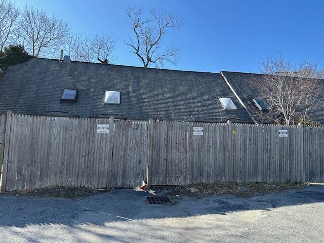 view of parking / parking lot featuring fence