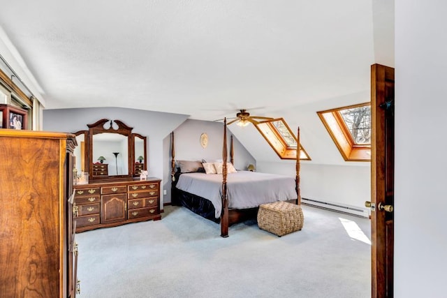 carpeted bedroom featuring baseboard heating, a skylight, vaulted ceiling, and ceiling fan