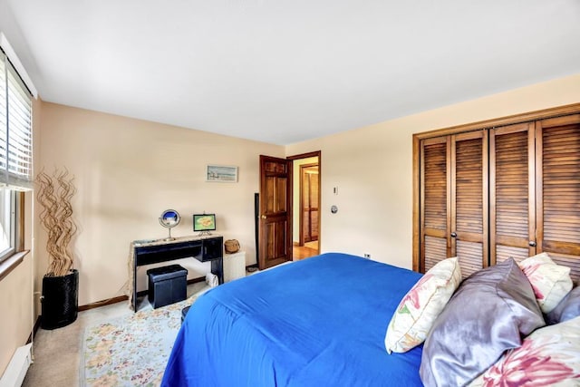 carpeted bedroom with a closet, a baseboard heating unit, and baseboards