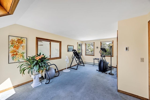 exercise room featuring carpet flooring, baseboards, and vaulted ceiling