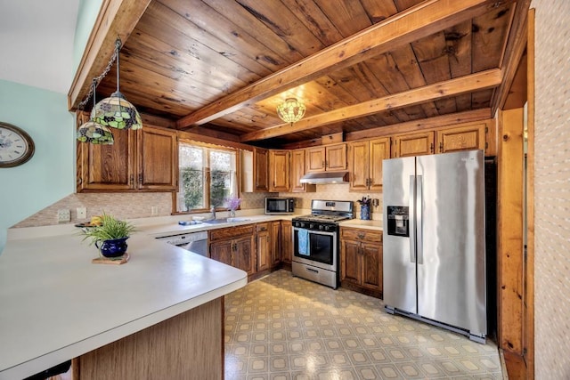 kitchen featuring appliances with stainless steel finishes, under cabinet range hood, wooden ceiling, light countertops, and brown cabinetry