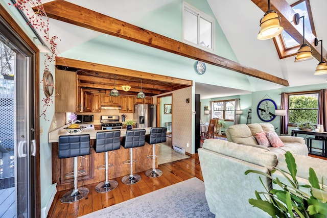 living room featuring hardwood / wood-style floors, beam ceiling, baseboards, and high vaulted ceiling