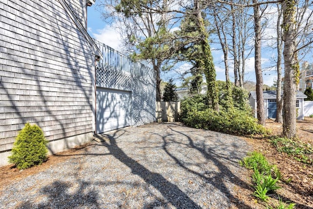 view of yard featuring asphalt driveway