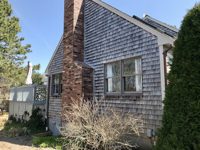 view of property exterior featuring a chimney