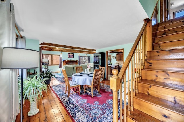 dining room featuring hardwood / wood-style flooring and stairway