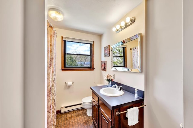 bathroom with a baseboard radiator, vanity, toilet, and baseboards