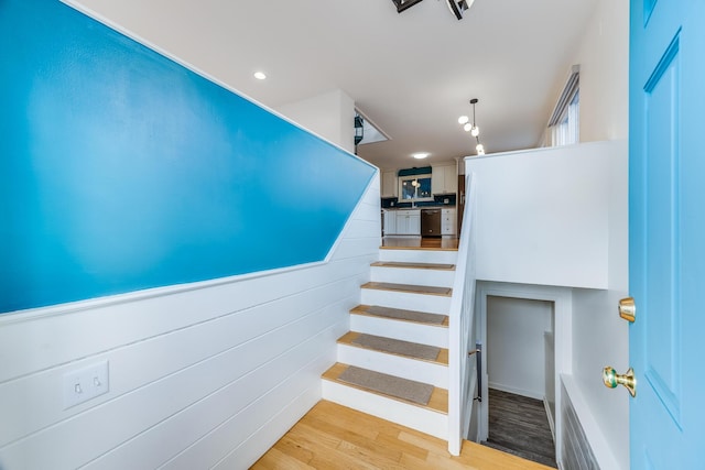 stairway featuring wood finished floors