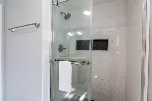 bathroom featuring a shower with door