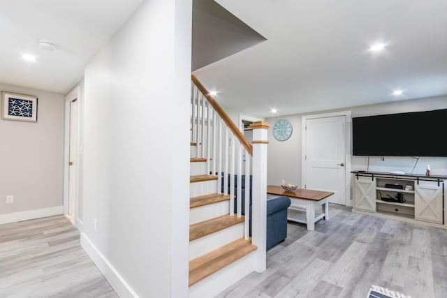 staircase with hardwood / wood-style flooring