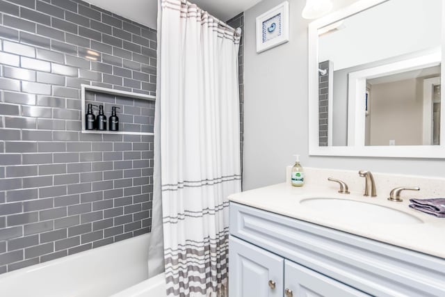 bathroom featuring shower / bath combo with shower curtain and vanity