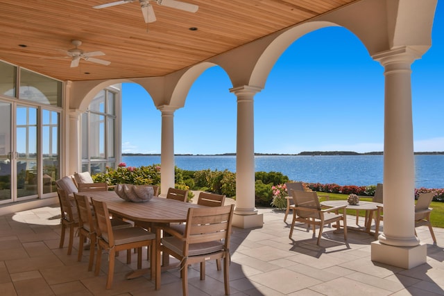 view of patio / terrace with ceiling fan and a water view