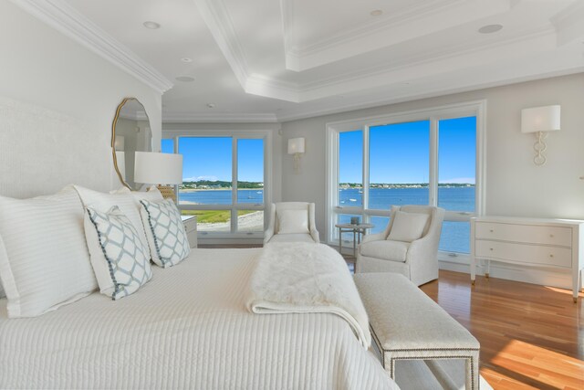 bedroom with crown molding, multiple windows, and a water view