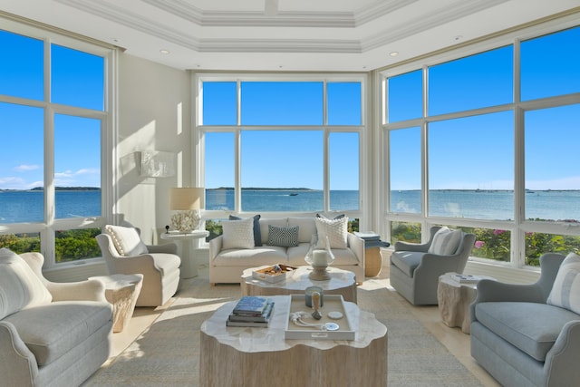 sunroom with a water view and a tray ceiling