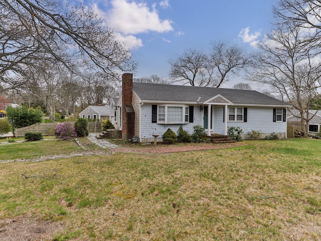 single story home featuring a chimney, fence, roof with shingles, and a front yard