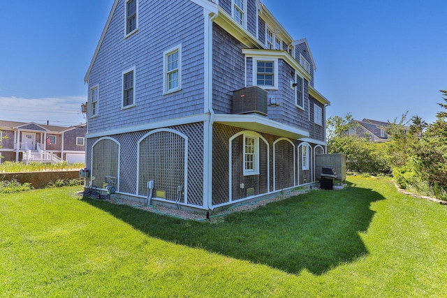 rear view of property featuring a yard