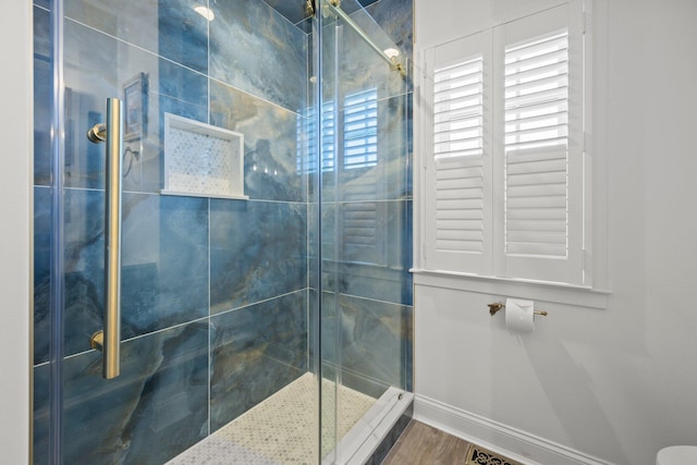 bathroom featuring hardwood / wood-style floors and walk in shower