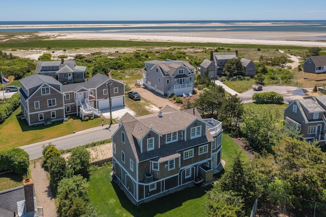 aerial view with a water view and a view of the beach