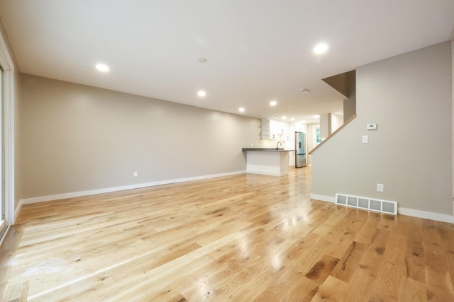 300 Buck Island Rd Unit C13F, West Yarmouth, MA 02673 - unfurnished living room with recessed lighting, light wood-type flooring, baseboards, and a sink