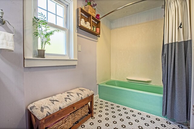 bathroom featuring tile patterned floors and shower / tub combo