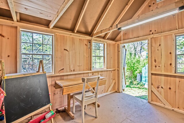 sunroom with vaulted ceiling and a healthy amount of sunlight