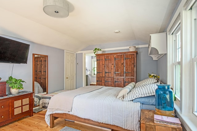 bedroom featuring vaulted ceiling and light hardwood / wood-style flooring