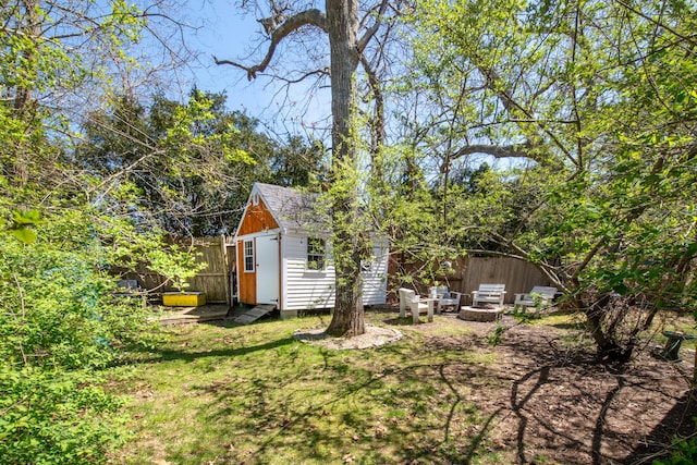 view of yard featuring an outdoor fire pit and a storage unit