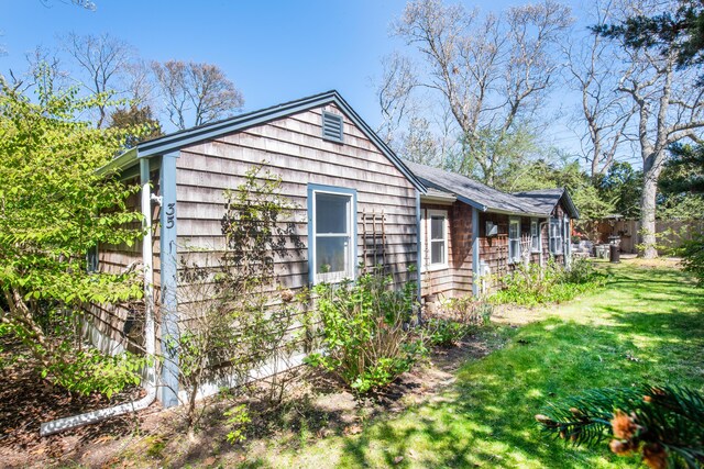 view of property exterior with a yard