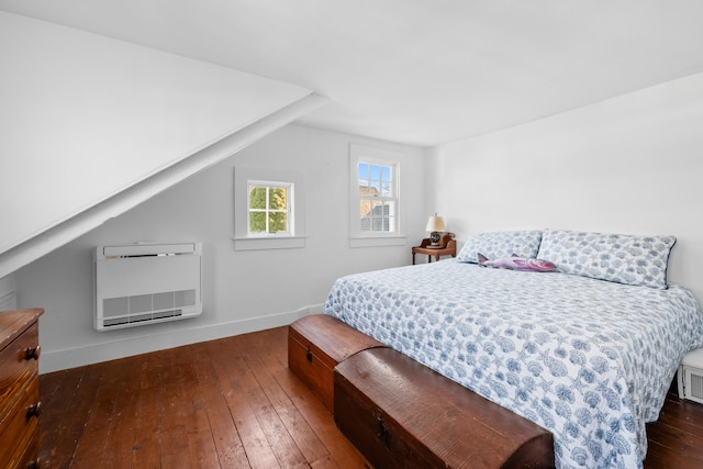 bedroom featuring dark wood-style floors, heating unit, visible vents, vaulted ceiling, and baseboards