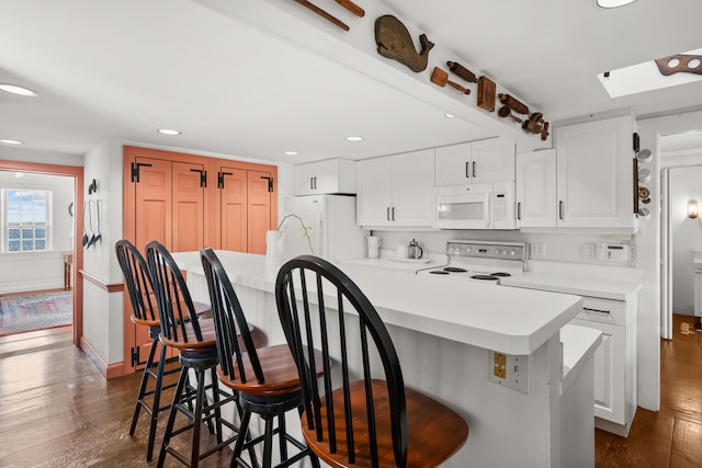 17 Harbor Rd, Harwich Port, MA 02646 - kitchen with dark wood finished floors, white appliances, and white cabinetry