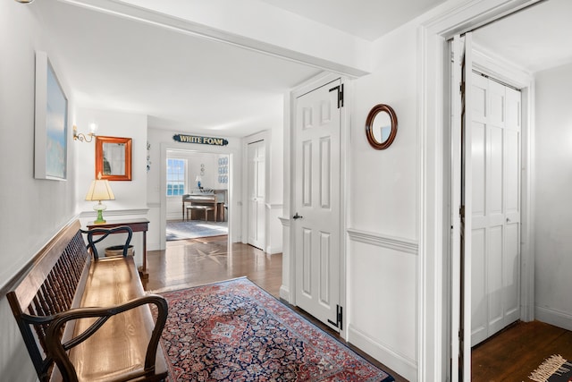 hallway featuring baseboards and wood finished floors