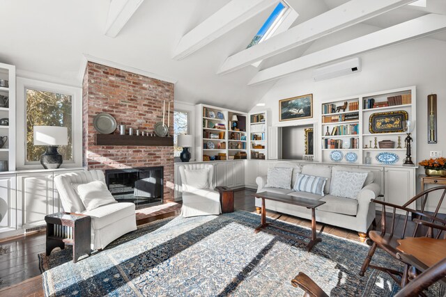 living room featuring lofted ceiling with beams, a wall unit AC, a fireplace, and wood finished floors