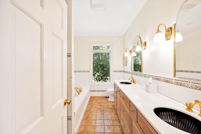 bathroom featuring vanity, toilet, a bath, and tile walls