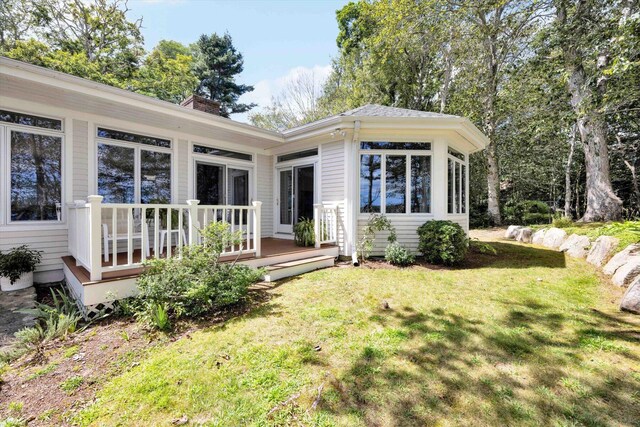 67 Redwood Cir, Mashpee, MA 02649 - back of property featuring a deck, a lawn, and a chimney